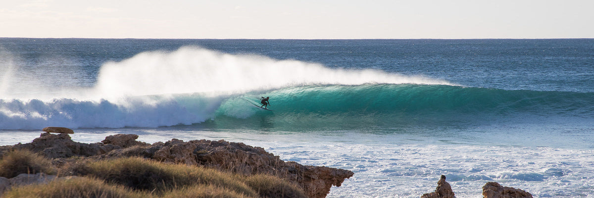 Surfer riding a wave along the Western Australia coastline