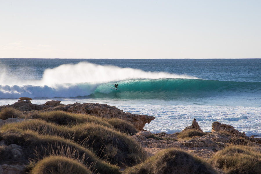 Red Bluff Western Australia, surfer riding wave along rugged coastline, surf photography – Sean Scott Photography