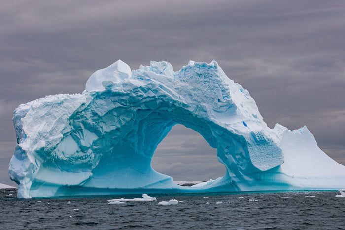 Antarctica, iceberg arch formation with vibrant turquoise water, fine art photography – Sean Scott Photography